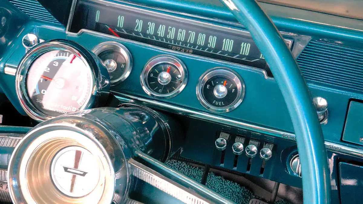 Close-up of 1962 Chevy dashboard gauges and aftermarket tachometer.