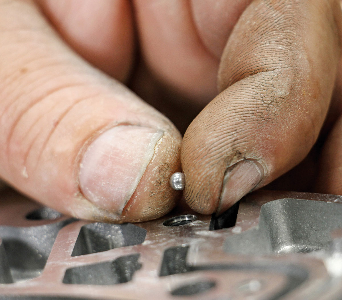 Inserting a small check ball into passage.