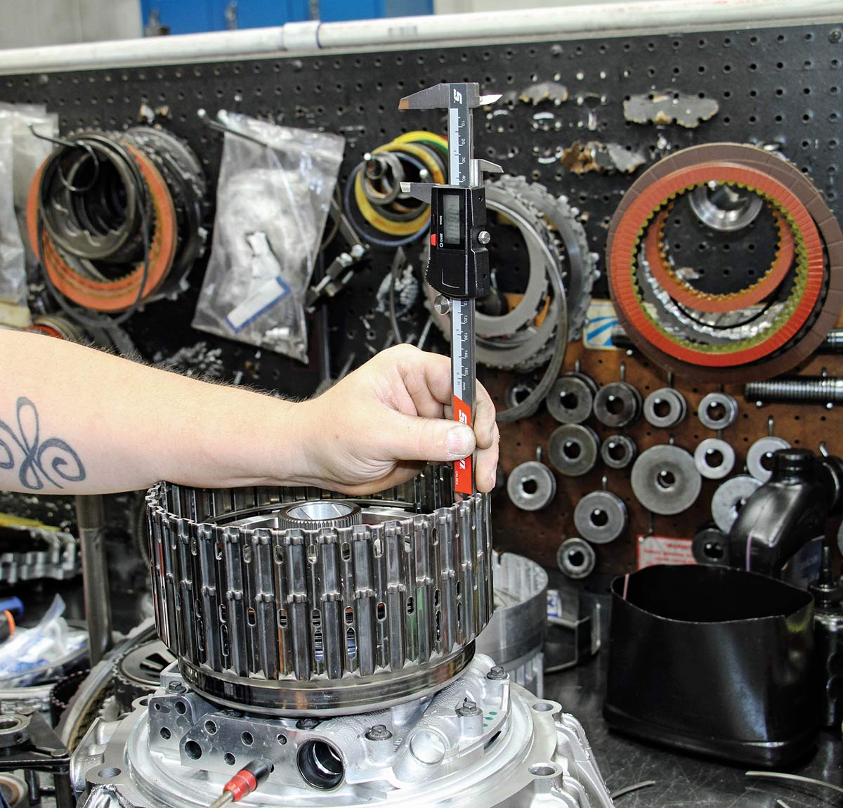 Measuring clutch pack travel with calipers.