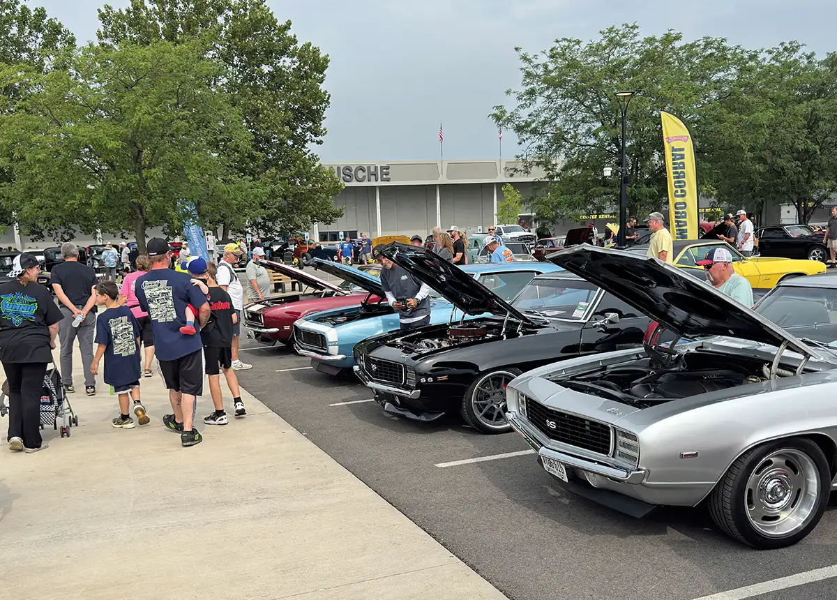 Row of classic Camaros parked at the car show.