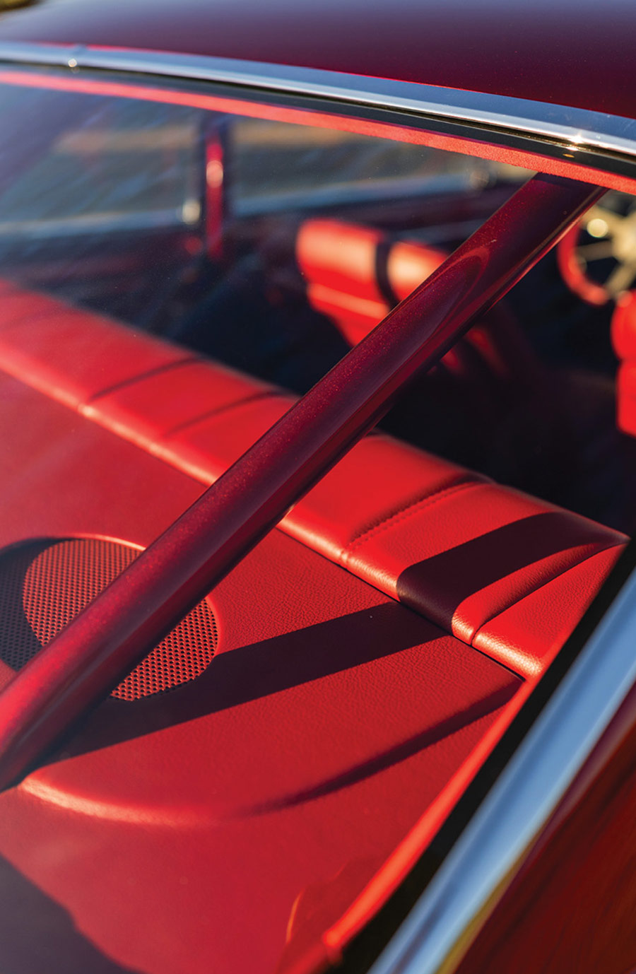 Rear window view of the roll cage and red upholstery.