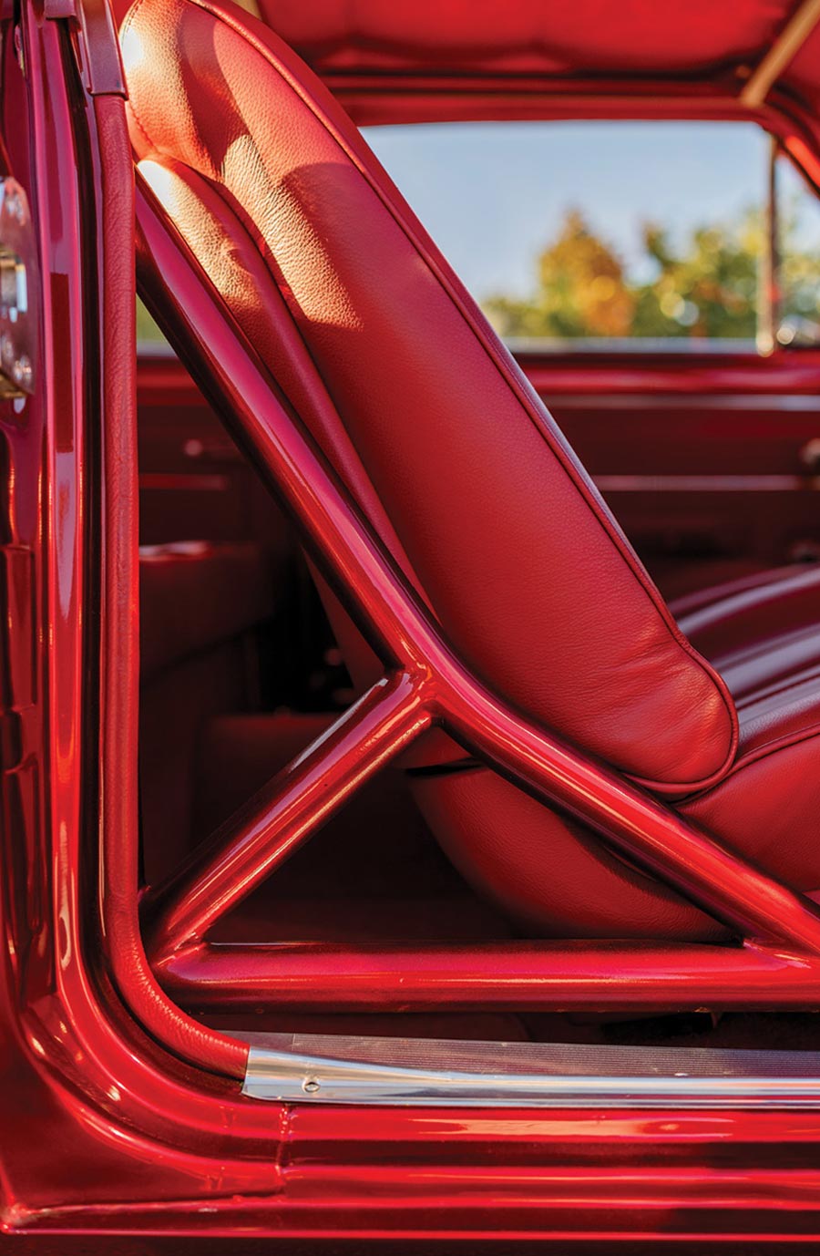 Integrated red roll bar reinforcement near the driver's seat.