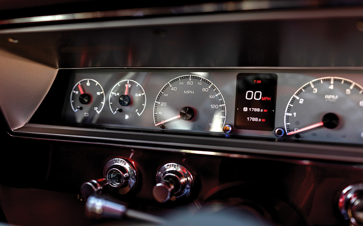 Close-up of digital gauges with red backlighting.
