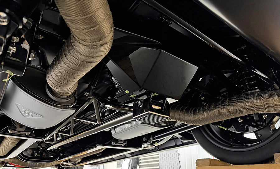 Underbody surfaces finished with heat wrapped exhaust.